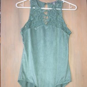 A teal green body suit